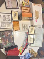 Overall view of assorted decor, kitchenware, textiles and tin on tabletop