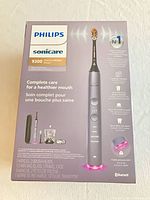 Front of sealed Philips Sonicare 9300 DiamondClean Smart toothbrush box showing contents and features