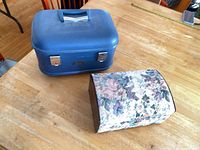 Blue train case and floral jewelry box closed, size context
