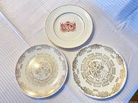Three commemorative plates front view