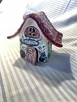 Front view showing welcome sign, door, windows, roof detail