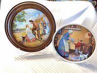 Both collector plates on stands displaying exterior artwork details