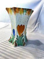 Front of star-shaped floral vase showing decoration