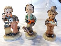 Front view of three Hummel figurines