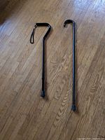 Both canes full length on hardwood floor