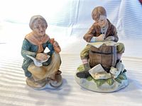 Front view of both painted porcelain figurines