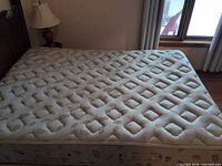 Mattress top view showing quilted diamond tuft pattern and overall condition