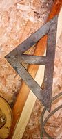 Full view of triangular square on wood surface