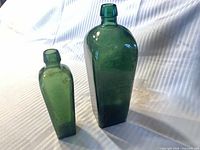 Front view of both green glass bottles