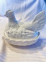 Full view of hen-shaped covered dish on base