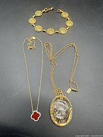 Overview of all three jewellery items laid out on black background