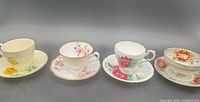 Group view of all four teacup and saucer sets