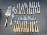 Full set layout: 12 knives, 12 forks, 2 serving pieces