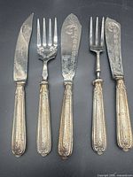 All five silver serving pieces in one view