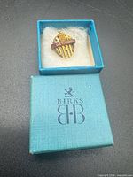 Brooch inside open Birks turquoise box