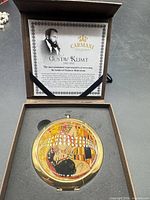 Compact mirror in open presentation box with certificate visible