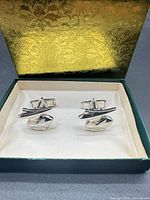 pair of cufflinks in open presentation box