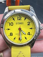 Front view showing yellow dial, brand, water resistant marking