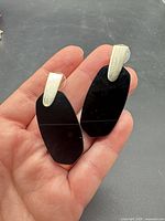 Front view of both earrings showing black stone drops and gold-tone tops