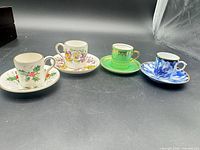 Four demitasse cups and saucers front view