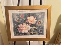 Full view of framed floral watercolour painting on easel