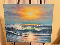 Full view of seascape painting on easel