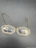 Front view of both silver bottle tags and chains