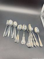 Full set of mixed stainless steel flatware laid out