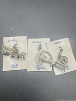 All three sterling charms on cards