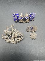 Front view of the three sterling brooches