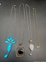 All four sterling silver necklaces laid out side-by-side