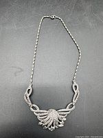 Full necklace laid flat showing chain, centerpiece, and clasp