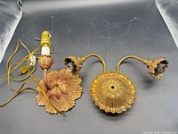 Top view of both metal wall sconces showing design, wiring and finish