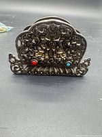 Front view showing complete ornate design and cabochon accents