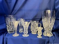 Front view showing all seven crystal pieces against blue backdrop