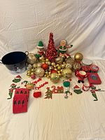 Full grouping showing ornaments, tinsel tree, plush figures, bucket and other items