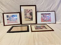 Group shot of five framed prints and frames