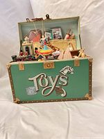 Front view showing green trunk, Toys lettering, interior toys