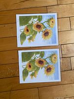 Two identical sunflower prints unframed