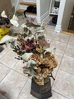 Large bouquet in vase showing eucalyptus, cockscomb, baby’s breath, roses, berries