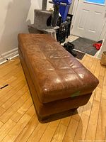 Top angled view of the brown upholstered bench