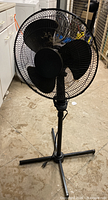 Full view of black pedestal fan front