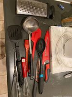 All utensils laid out showing variety and condition
