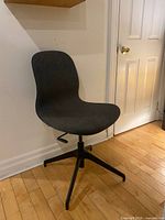 Front side view of chair showing upholstery and pedestal base