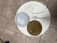 Top view of diffuser reservoir and woodgrain cover with attached power cord