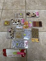 All sealed packs of beads, charms and crochet hook laid out on floor