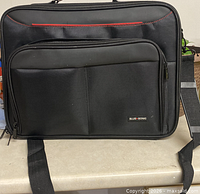 Front view showing Blue-Sonic branded laptop bag with front pocket and red accent