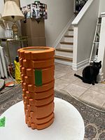 full view of orange foam roller upright