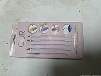 Front view of sealed QUR nail art brush set showing six brushes
