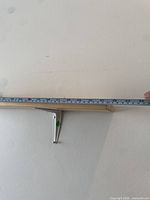 Shelf measured with tape showing length and bracket detail